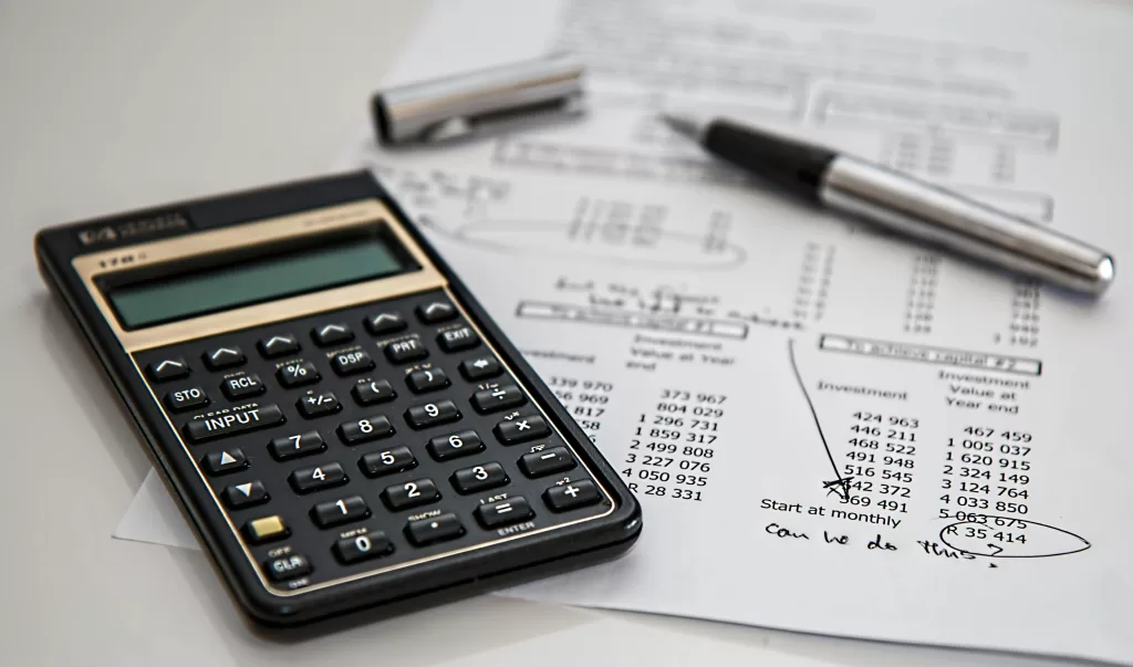 budgeting with pen and calculator