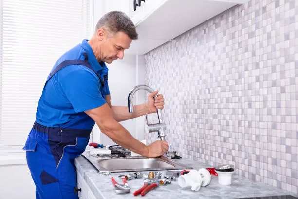 man installing sink