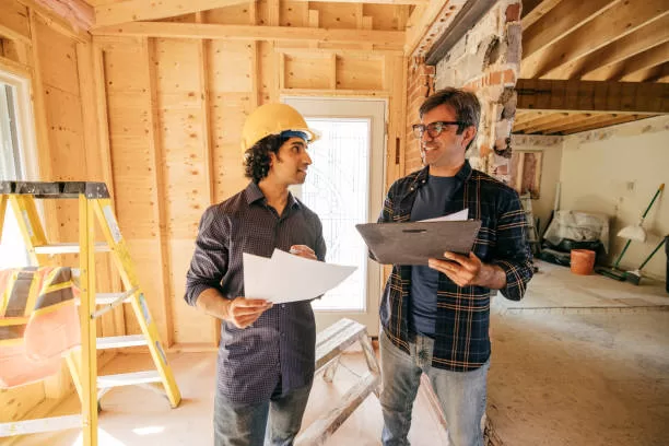 Engineer and architect  reviewing details of home renovation.