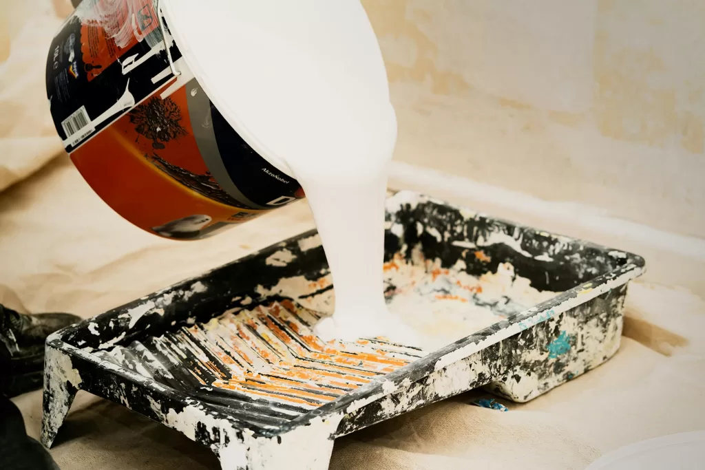 Paint pouring into paint pan
