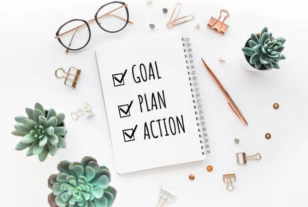 Goal,plan,action text on notepad with office accessories.Business motivation,inspiration,professional performance concepts