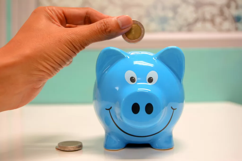 Putting coin in piggy bank