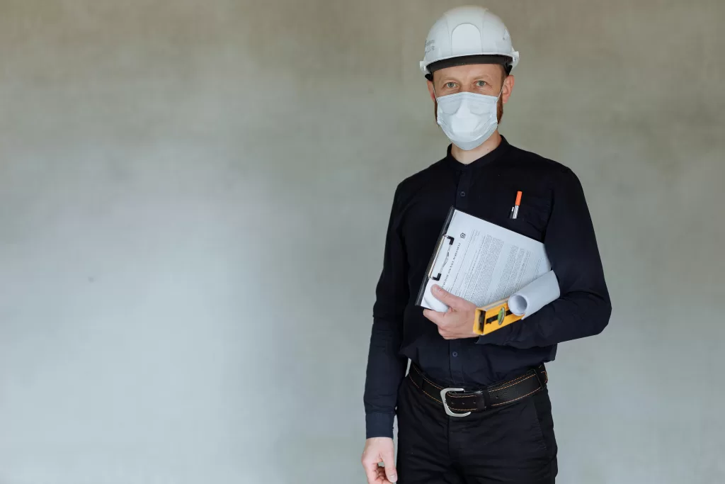 Contractor wearing mask holding clipboard