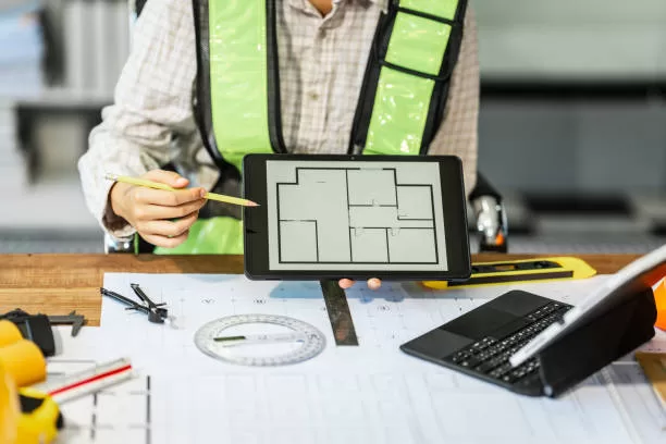 Female architect engineer is drafting blueprints using CAD software, focusing on sustainable infrastructure, renewable energy solutions, and adhering to building codes