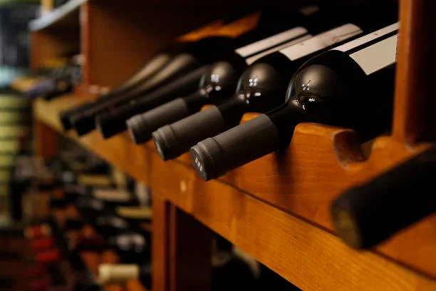 many bottles of wine in row perspective in a cellar