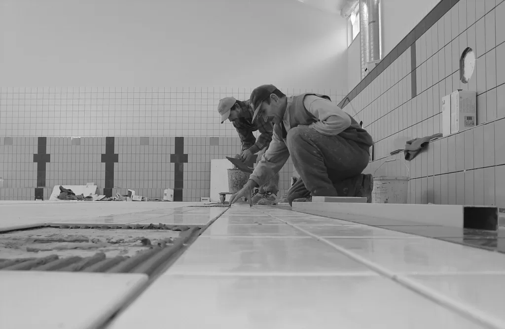 Two men preparing for a bathroom renovation