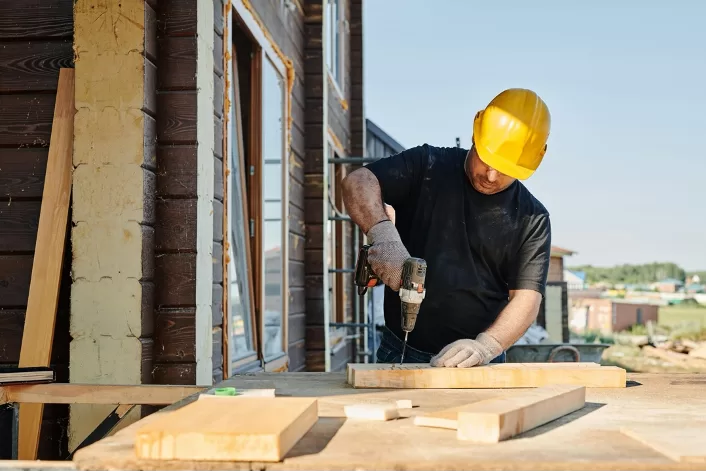 carpenter drilling wood.