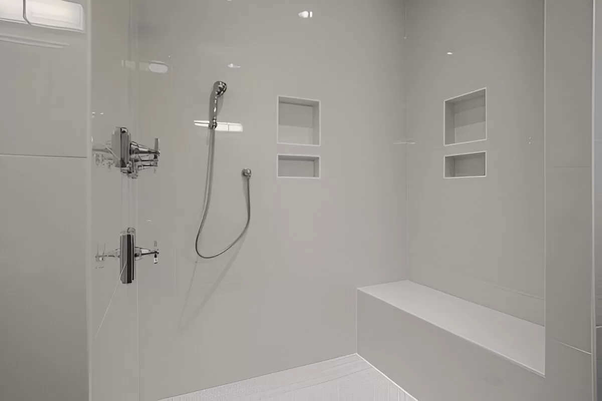 Porcelain tile shower with recessed niche and bench in a Toronto home.
