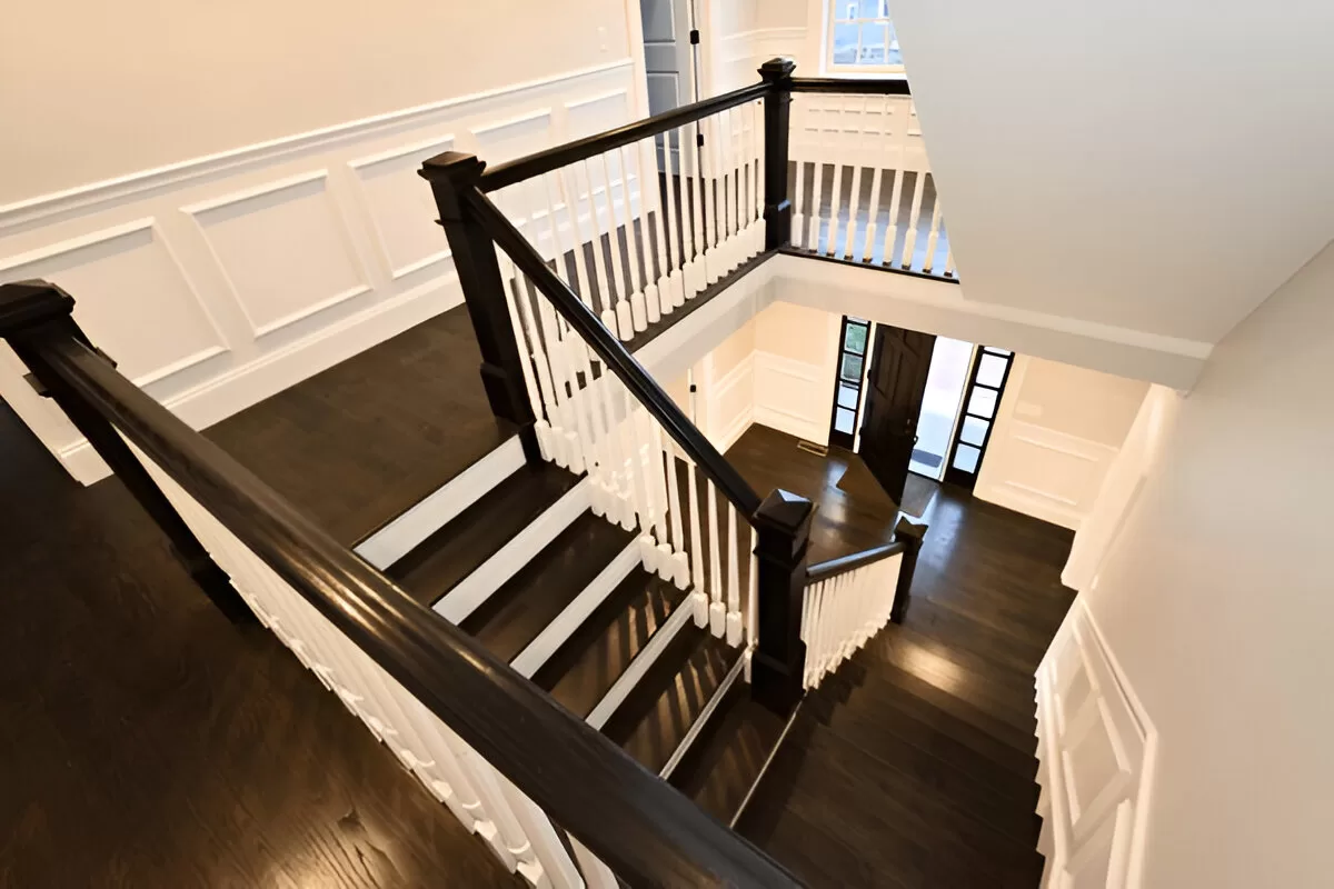 Cream white walls with black stair rail for classic contrast in Toronto house.