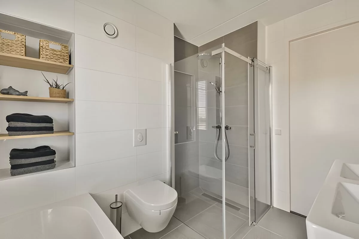 Toronto 5×8 bathroom remodel with curbless shower and fixed glass panel.