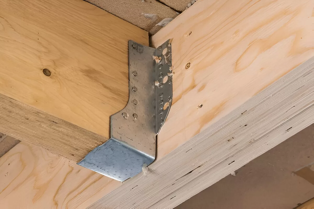 Pressure‑treated deck framing with hot‑dipped galvanized joist hangers in Toronto.
