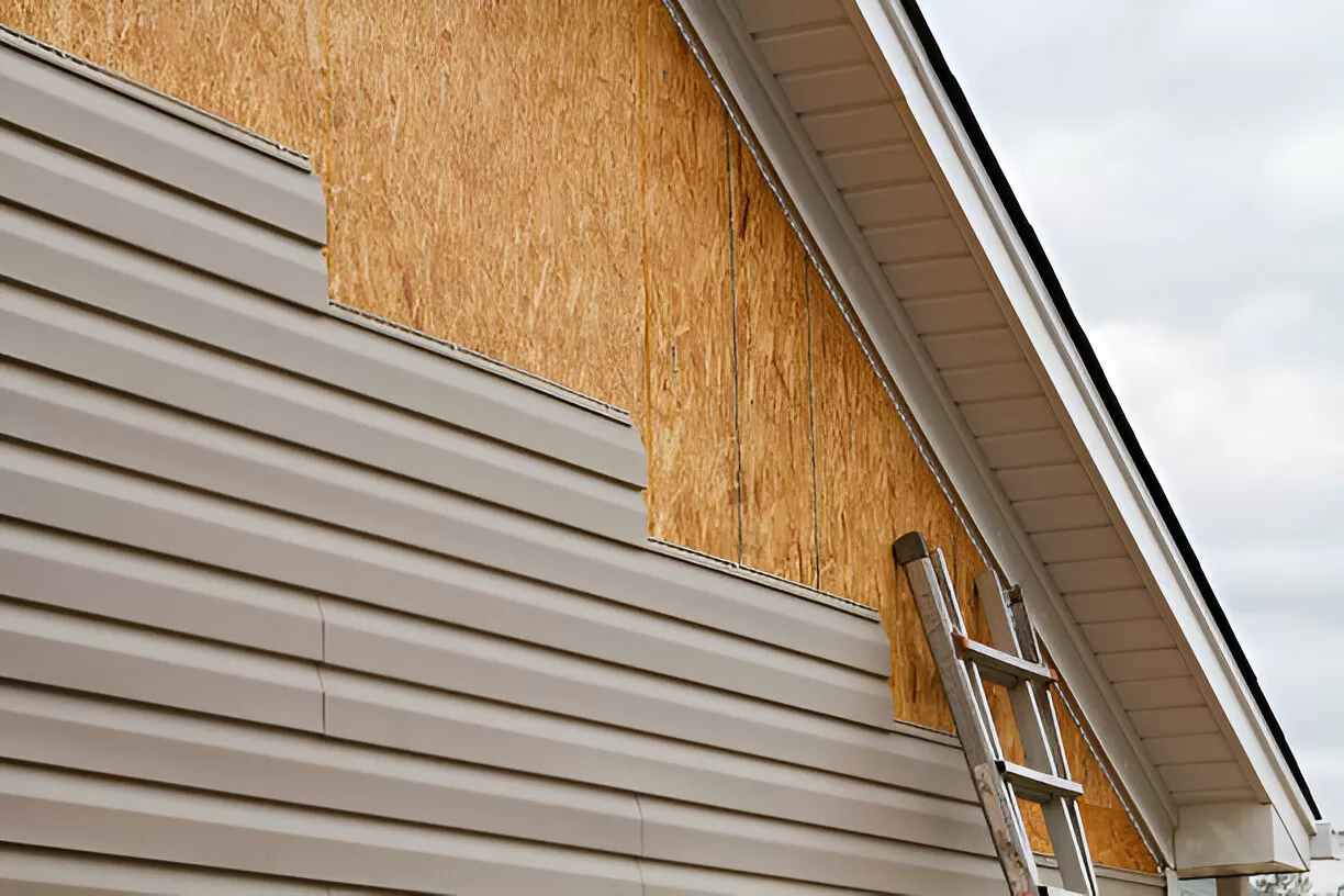 Aged vinyl siding compared with new durable cladding on a Toronto house.