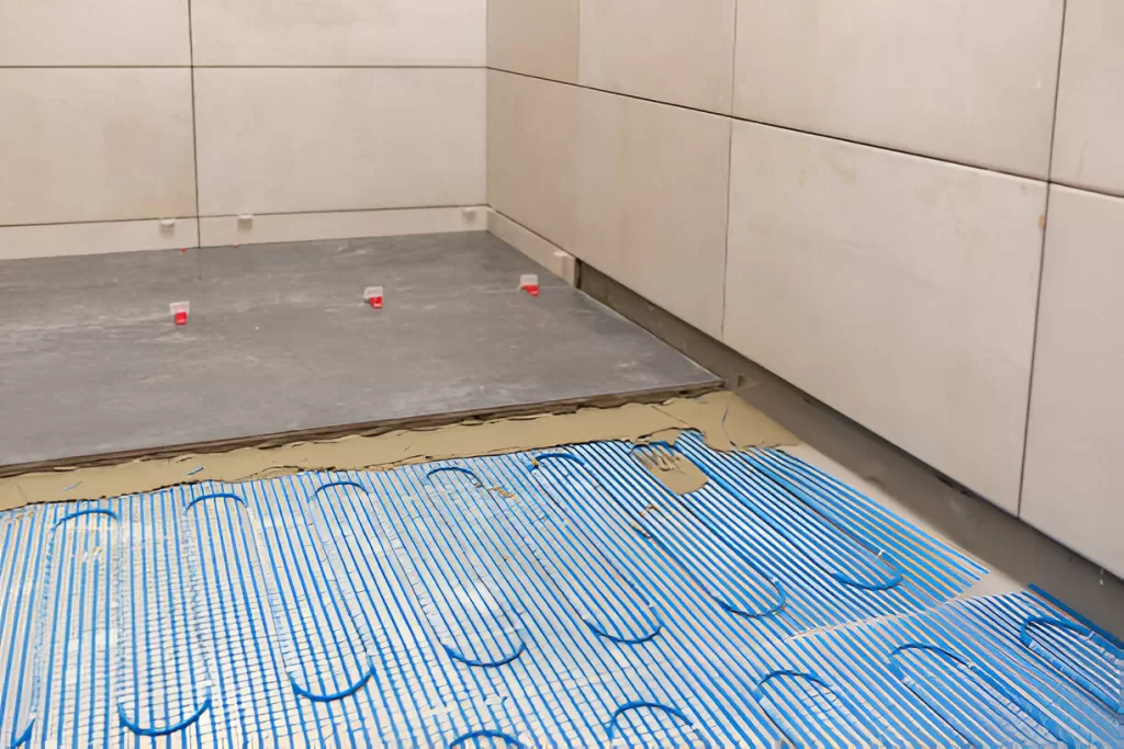 Electric floor heat set in uncoupling membrane Toronto shower.