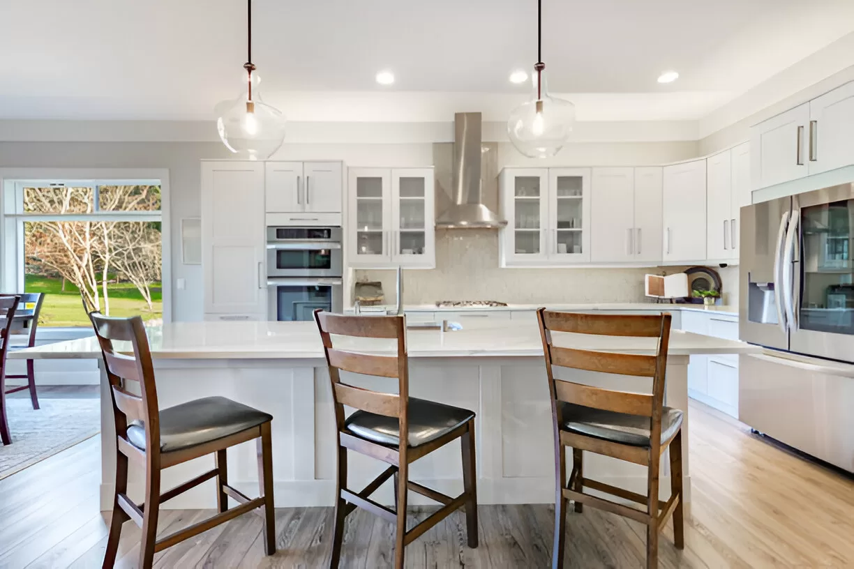 Open concept Toronto kitchen with island hood controlling cooking odors.