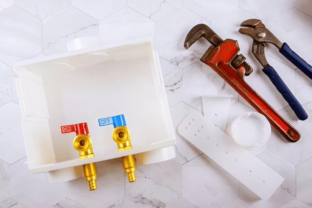 Recessed laundry box with quarter‑turn valves and standpipe.