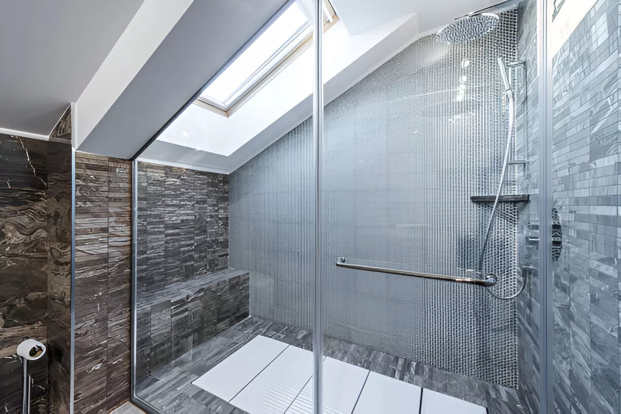 Steam shower with sloped ceiling and sealed door in Toronto home.