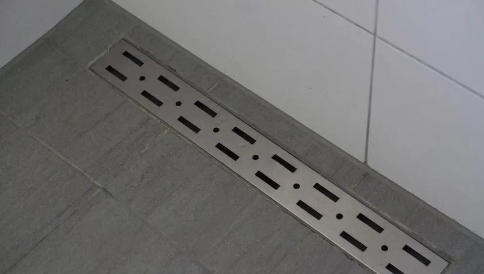 Curbless shower with linear drain for quick drying.