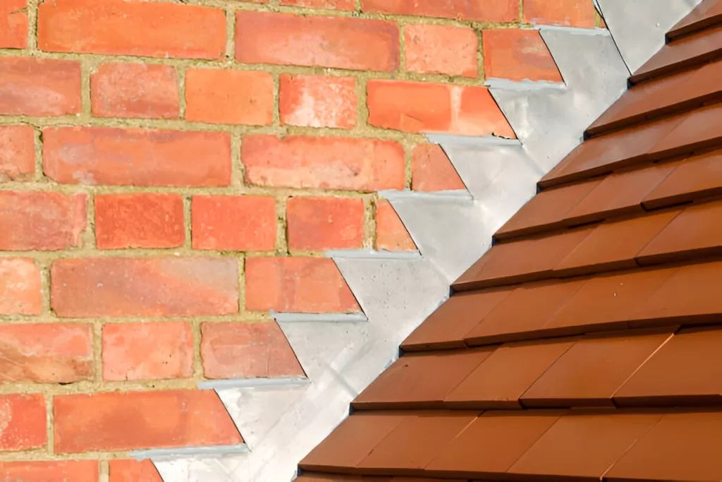 Step flashing installed at a sidewall on a Toronto roof.