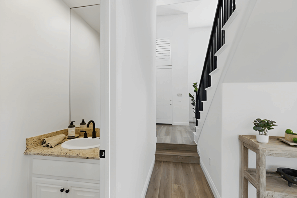 Under-stair powder room with compact toilet and floating sink in Toronto home.