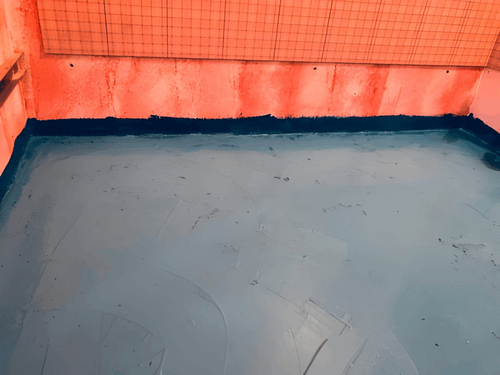 Sheet membrane waterproofing installed in a curbless shower with banded seams.