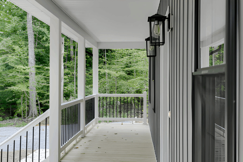Toronto porch with code‑compliant metal railing and wood stair treads.