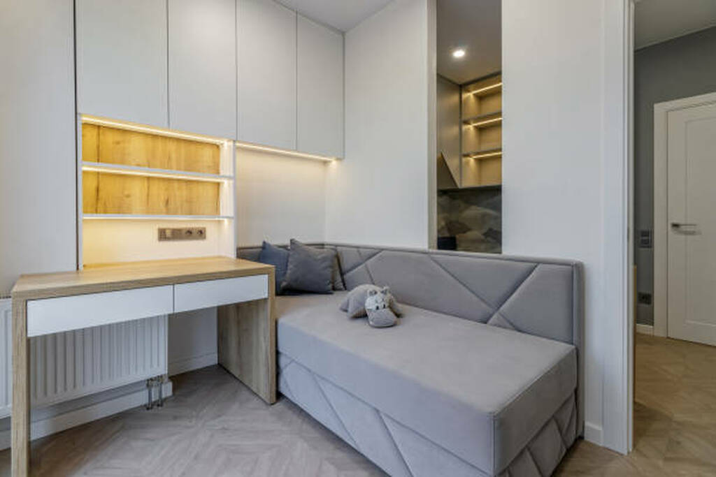 Flex room with sofa bed and built in desk used as both guest room and home office.