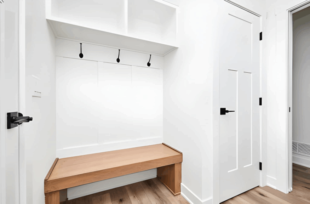 Toronto entry closet and built-in bench with hooks and shoe storage creating a mini mudroom.