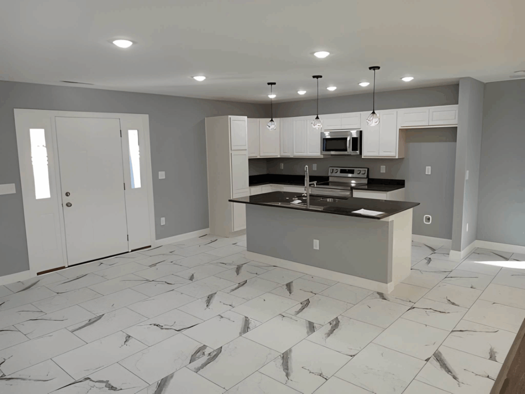 Modern Toronto kitchen with new flooring, white cabinets, and an island.