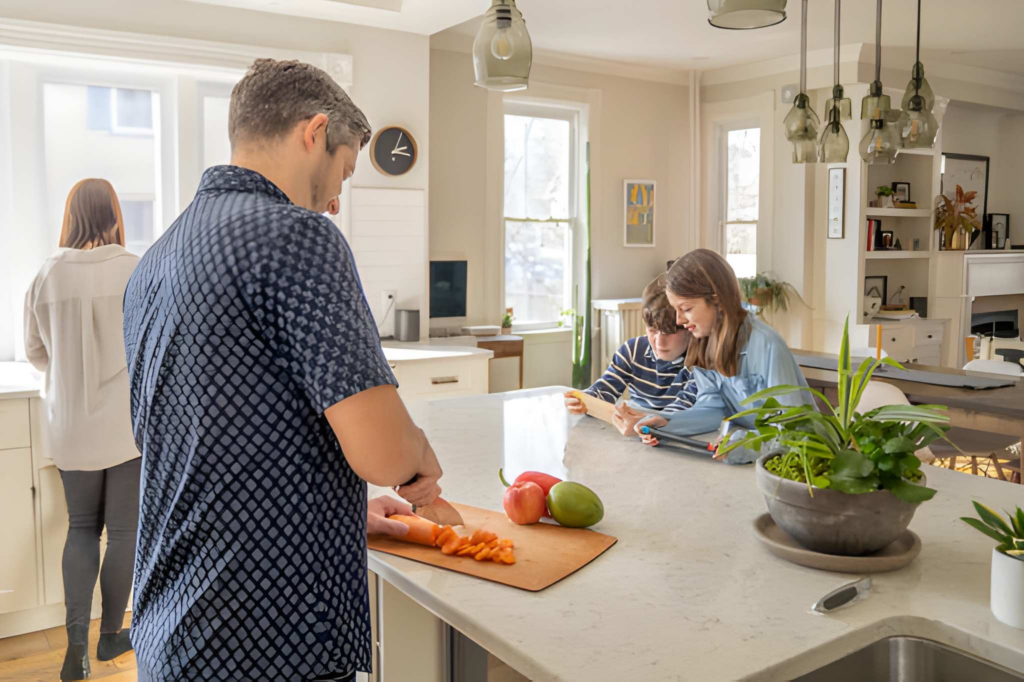 Family using a kitchen island for cooking and homework at the same time