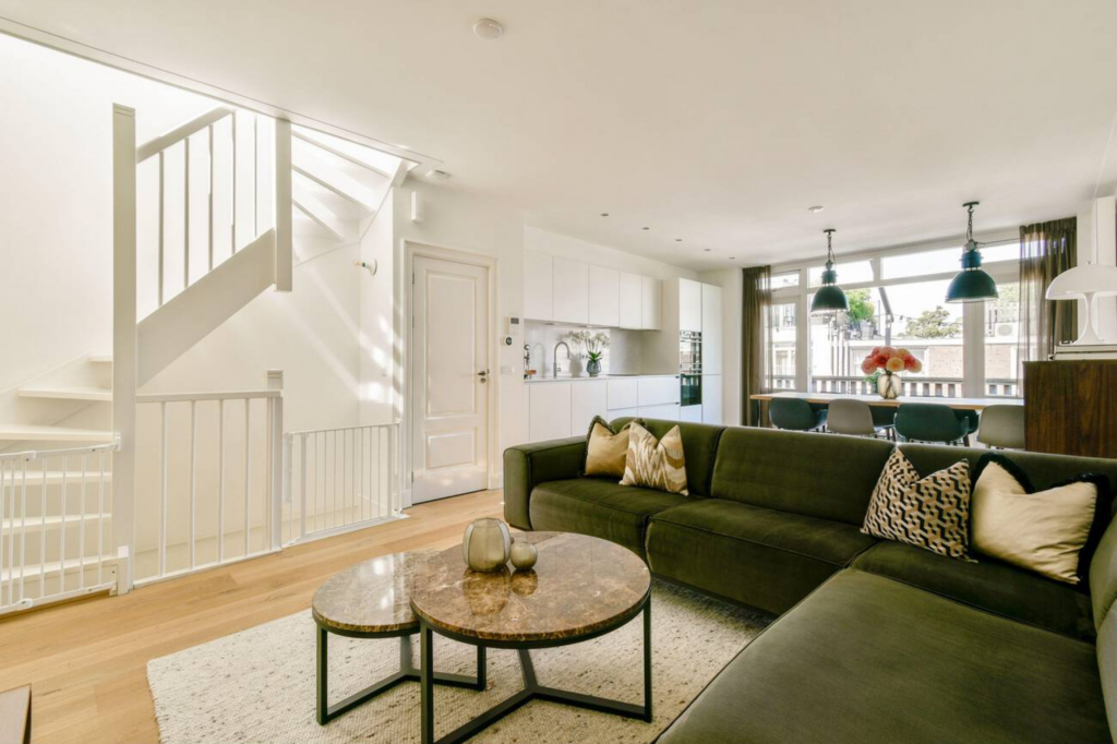 Bright renovated Toronto living room with sofa, rug, and large window.