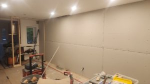 Roselawn Ave process. living room wall, drywall placed