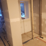 Roselawn Ave process. living room corner primed & framed